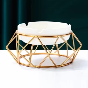 white ceramic ashtray with golden metallic stand